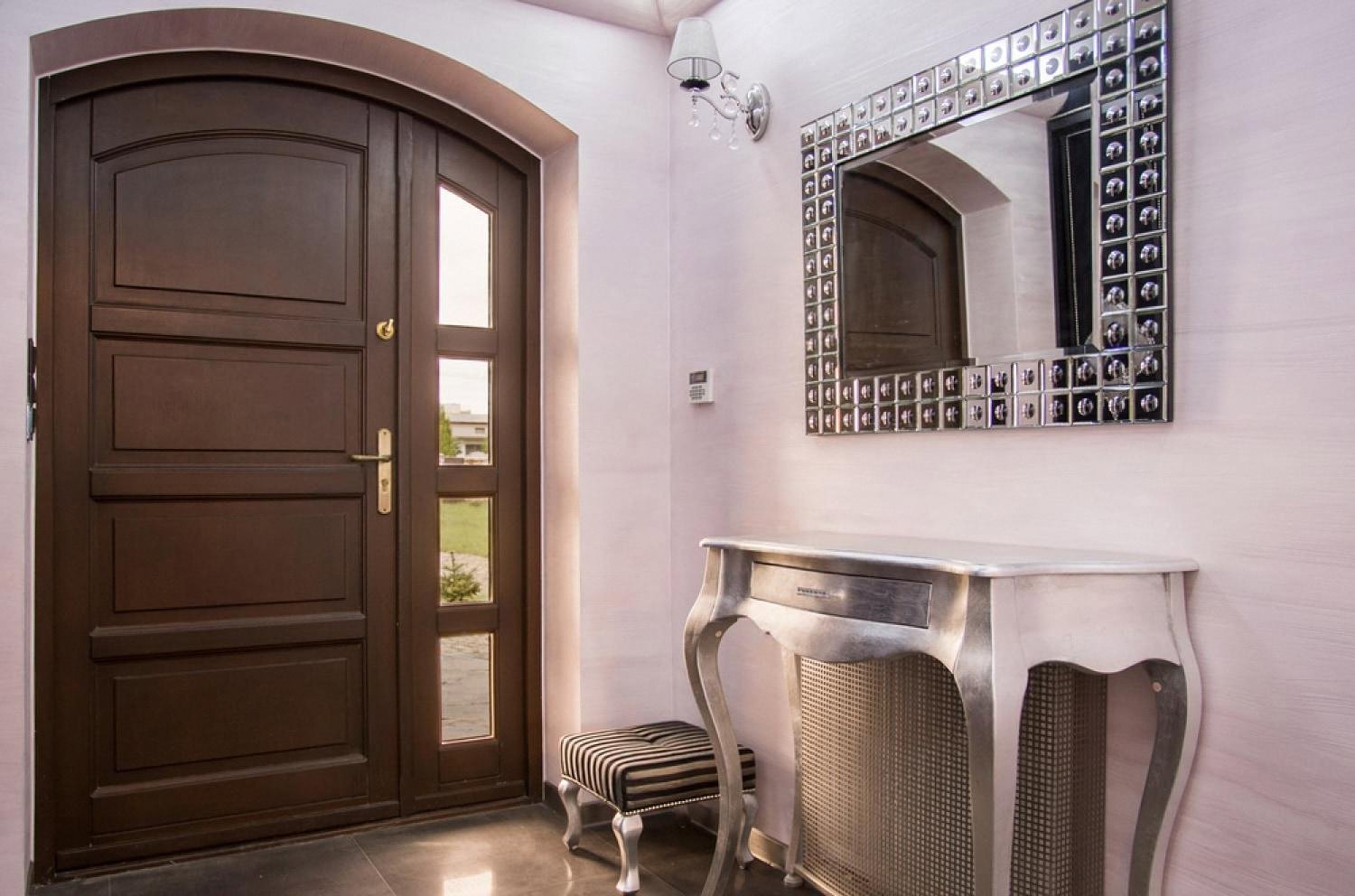 Reinforced dark wood entrance door inside a villa hallway